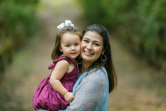 Mom Holding Preschool Toddler Daughter Girl With Strong Bond And Love