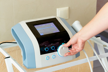 Close-up doctor's hand on the instrument panel of medical equipment. Close-up doctor switch on a medical device.