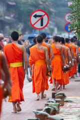 Buddhist novice monks with buddhist alms giving ceremony at Luang Prabang.