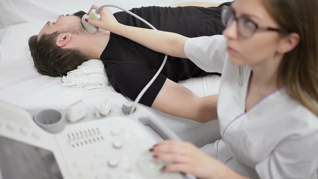Man Being Checked for Thyroid at Ultrasound Device 