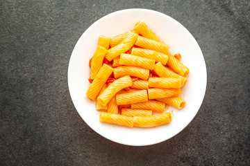 Penne Amatriciana fresh pasta with parmesan cheese on dark backg