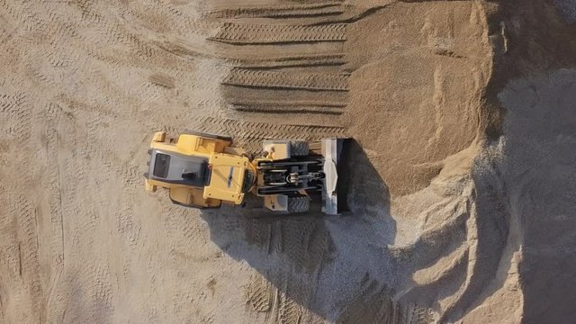 Bulldozer in action in open air quarry