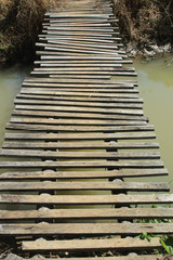 Obraz premium Landscape with a wooden bridge over a river