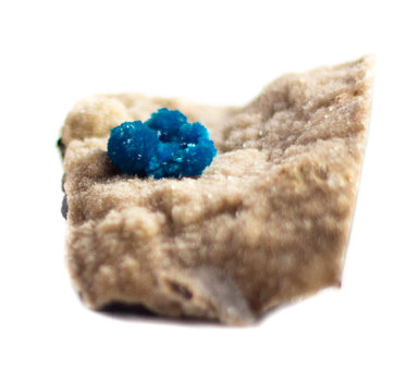 Natural cluster blue cavansite on the substrate on a white background isolated