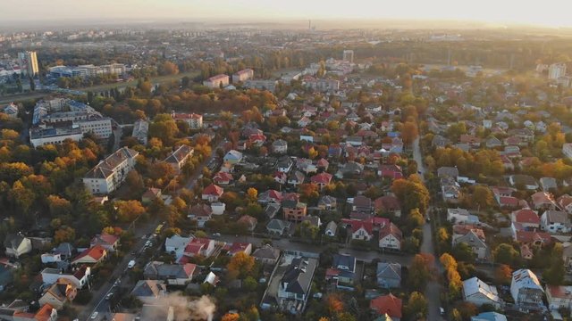 View from the height of the city on the roofs of houses, trees, mountains in the Cloudy sky. Cloudy sky.