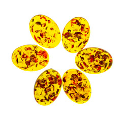Polished cabochons of artificial amber on white background isolated