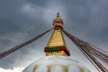 Landscape front view of Boudhanath Stupa and prayer flags. Kathmandu, Nepal. Boudha Stupa is one of the largest stupas in the world.