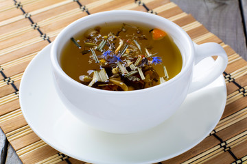 green tea on a wooden table in a white cup