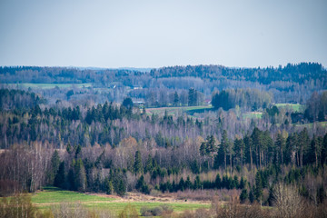 empty countryside landscape in autumn with fields and meadows and rare trees in background