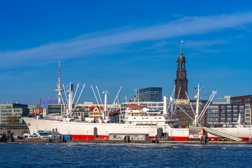 View of Hamburg harbor and downtown Hamburg, Germany, on a sunny afternoon.