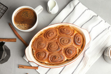 Flat lay composition with freshly baked cinnamon rolls on grey background