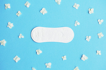 daily pad and fresh flowers on blue background