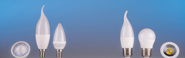 Led lamps stand a near the house layout on a blue background