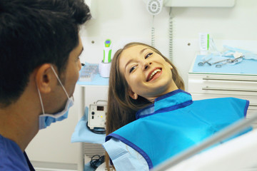 dental health concept woman at dental clinic smiling with the dentist.