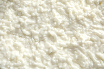 Fototapeta na wymiar Delicious creamy rice pudding as background, top view