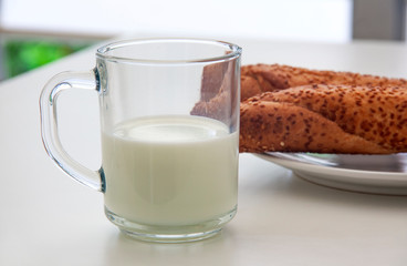 Cup of milk and bread with sesame