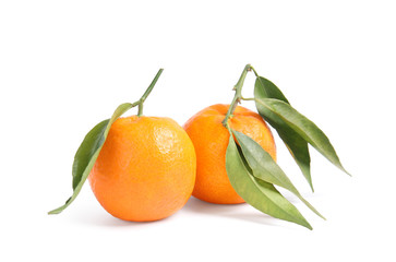 Tasty ripe tangerines with leaves on white background