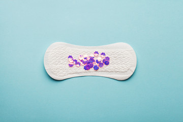 sanitary pad on blue background, women critical days, menstruation product