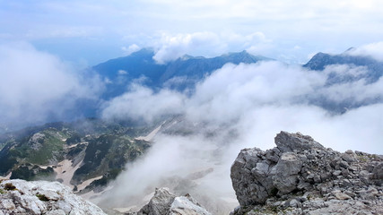 Top of the mountain view of the mountain peaks and valley covered in snow