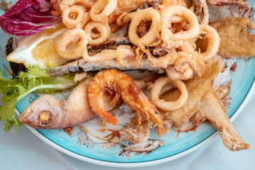 plate full of seafood, fishes, shrimps, calmars