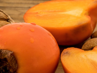 Delicious fresh persimmon fruit  on the wooden table close up