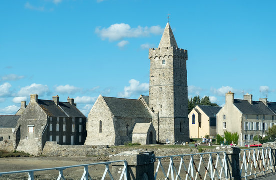 View of the Church Notre-Dame with fortified bell tower in Portbail. Normandy, France