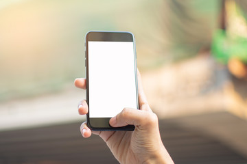 woman's hand holding smart phone with blur background. selective focus and soft focus.