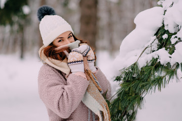 woman hides her face behind scarf because of cold