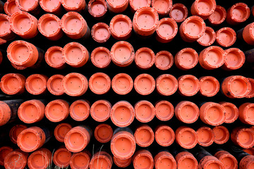Rows and patterns of iron metal pipes ends used for industrial oil and gas drilling