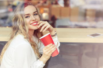 Woman Drink Her Hot Coffee While Sitting In Cafe. Portrait Of Stylish Smiling Woman In Winter Clothes Drinking Hot Coffee. Female Winter Style. - Image