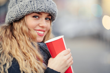 Woman Drink Her Hot Coffee While Walking On The Street. Portrait Of Stylish Smiling Woman In Winter Clothes Drinking Hot Coffee. Female Winter Style. - Image