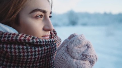 Close up face of a girl looking away frozen deep look in the winter park happy cold fun snow face forest happiness white sun nature season weather christmas vacation outdoor slow motion