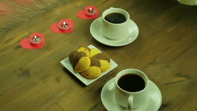 Young people in the cafe give each other gifts by candlelight
