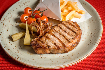 Cherry tomatoes Fragrant hot meat cooked on fire. Pork steak or beef