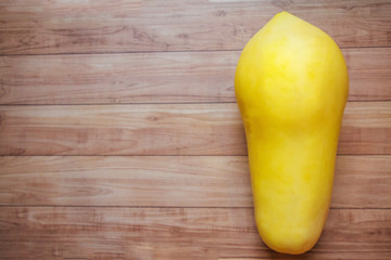 Golden Papaya on Brown Wood Flooring, Top View, Thai Creative