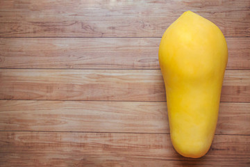 Golden Papaya on Brown Wood Flooring, Top View, Thai Creative