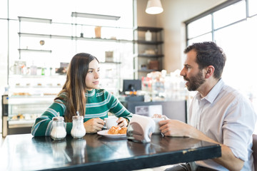 Couple Having Serious Discussion In Cafe
