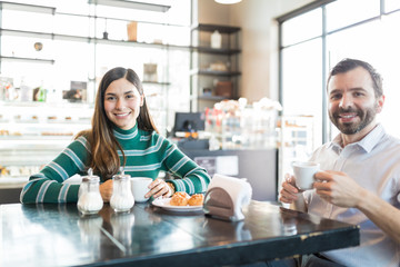 Couple Spending Leisure Time In Cafe