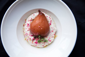 dessert spicy pear on a pillow in a white plate