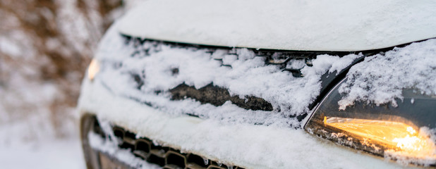 white car front covered in snow in winter season b