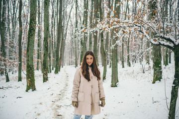 Sensual brunette winter girl posing and having fun. Laughing Girl Outdoors.
