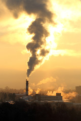 Smoke from the chimney and air pollution. Factory in the city. Industry. 