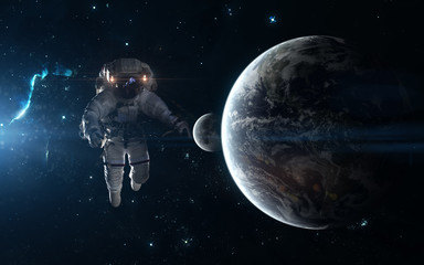 Astronaut, Earth and Moon on background of star clusters. Science fiction art. Elements of the...