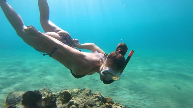 Underwater footage of girl snorkeling with coral reef and tropical fish in the Caribbean Sea