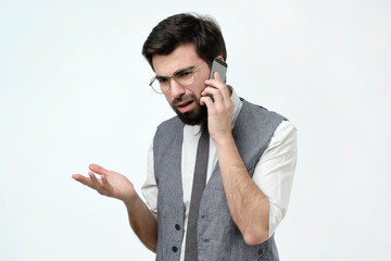 Angry spanish man talking on the phone isolated on white background