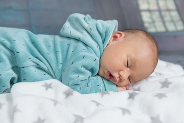 sleeping newborn baby on a blanket