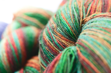 Knitting. Multi-color coil of natural wool yarn, coiled with hands