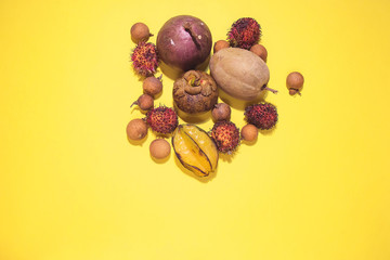 exotic fruits mangosteen, carambola, rambutan, longan and others on a yellow background isolated. Tropical fruit freshness, healthy food, diet