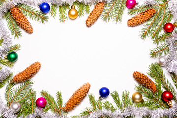 Beautiful Christmas frame decorated with fir tree branches colorful toys and cones on white background