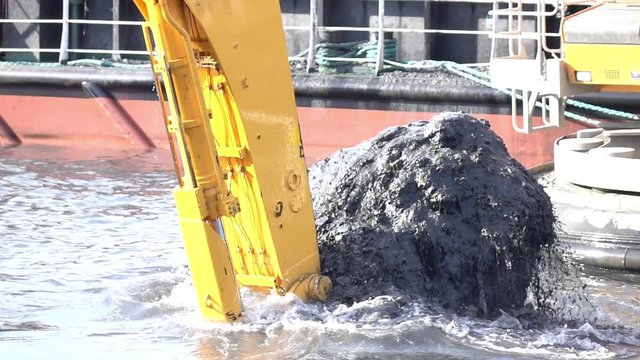 Water pipe excavator job by backhoe for cleaning dirt at canal